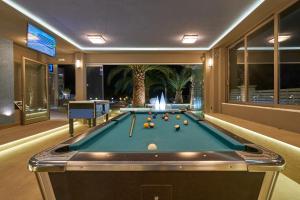 a billiard room with a pool table and a fountain at Ionion Blue Hotel Zante in Kalamaki
