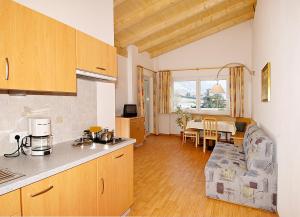 a kitchen and a living room with a table at Residence Andrea in Lagundo