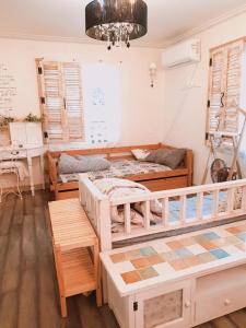 a room with two beds and a table at The Antique in Busan
