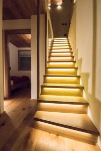 a staircase in a house with yellow steps at b&bTerre Aromatiche in Chiesa in Valmalenco