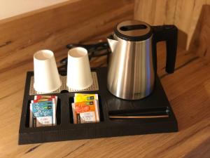 a black tray with a coffee maker and paper towels at Fulun Mountain Lodge in Giustino