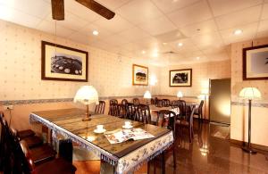 a restaurant with a table and chairs in a room at Old Wind City Private Lodging in Wujie