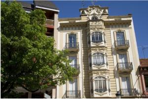 a tall building with a tower on top of it at Casa Oroela in Jaca