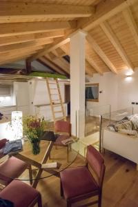 a living room with a glass table and chairs at b&bTerre Aromatiche in Chiesa in Valmalenco