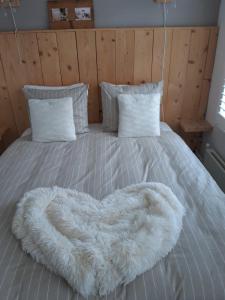 a bed with a white comforter and pillows at De Slapende Leeuw in Middelburg