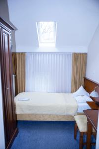 Säng eller sängar i ett rum på Hotel Baden