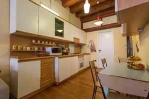 a kitchen with white cabinets and a counter top at My Lovely Home in Cagliari