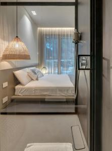 a bedroom with a bed and a window at Le Palmette Suites in Cagliari