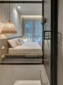 
a bedroom with a bed and a window at Le Palmette Suites B&B in Cagliari
