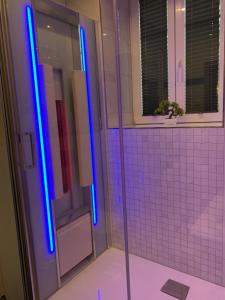 a bathroom with a shower with blue lights on it at Wieko Ferienwohnungen - Luxus pur im Prinz von Preußen, Erdgeschoss in Bad Elster