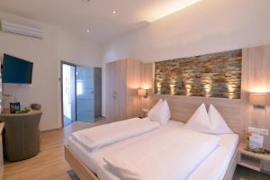 a bedroom with a large white bed in a room at Gasthof Ziegler Hotel & Restaurant in Lindau