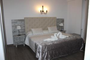 a bedroom with a bed, dresser and a lamp at Boutique Hostal Mistral in Cala d´Or