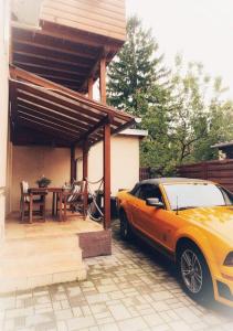 a car parked in front of a house with a table at Dora Holiday House & Apartments in Keszthely
