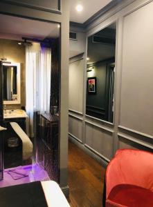 a room with a bed and a bathroom with a mirror at Saint B Boutique Hotel STB in Rome
