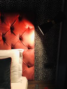 a bedroom with a bed with a red head board at Saint B Boutique Hotel STB in Rome