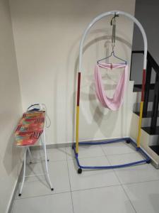 a room with a metal stand and a pink cloth at Idham Homestay in Ipoh