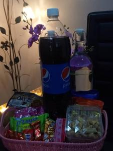 a basket with a bottle of pepsi and some snacks at Idham Homestay in Ipoh
