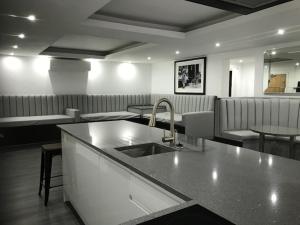 a kitchen with a sink and a counter top at The Picture House Apartments in Liverpool