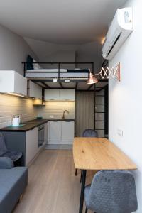 a kitchen and dining room with a table and chairs at Apartment NEARTO Old Town Miodowa Street in Krakow