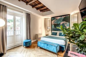 a bedroom with a bed and a large painting on the wall at Hotel 55 Fifty-Five - Maison d'Art Collection in Rome
