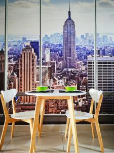 a table and chairs with a view of the city at KSL D'esplanade Johor Bharu in Johor Bahru