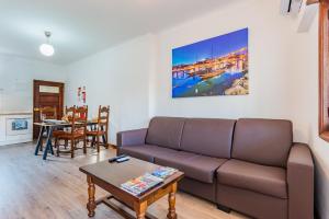a living room with a couch and a table at Riverside City Centre Apartments in Porto