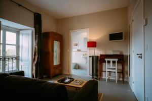 a living room with a couch and a table at el gran sueño Boutique Hotel & Apartamentos - Adults Only in Pintueles