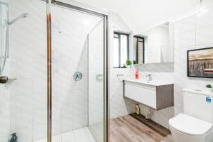 a bathroom with a shower and a toilet and a sink at 1 Private Double Room In Berala 1 minute away from Train Station - ROOM ONLY in Regents Park