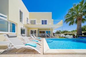 a villa with a swimming pool and a house at Porto de Mos 95 by Destination Algarve in Porto de Mós