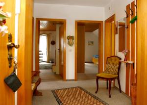 a room with a hallway with a chair and a door at Ferienwohnungen Annegret Schütte in Winterberg