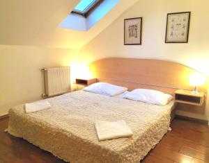 a bedroom with a large bed with two towels on it at Apartment Amandment in Prague