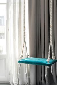 a swing hanging from a window at Colors Urban Hotel Thessaloniki in Thessaloniki