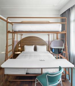 a bedroom with a bunk bed and a chair at Colors Urban Hotel Thessaloniki in Thessaloniki