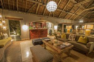 a living room with a couch and a table at Thornybush Simbambili Lodge in Sabi Sand Game Reserve