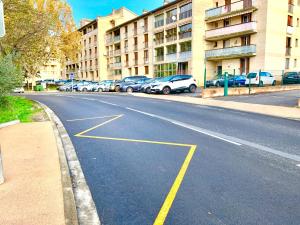 an empty street with cars parked on the side of a building at PERLE Studio in Manosque