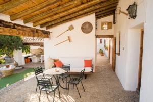patio ze stołem i krzesłami w obiekcie Cortijo Rural Majolero w mieście Castillo de Locubín