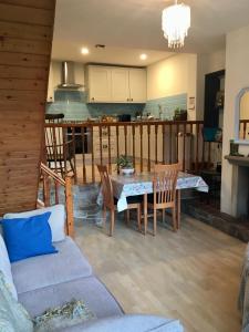 a living room with a table and chairs and a kitchen at Windsor View in Hebden Bridge