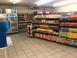 a grocery store aisle with shelves of food and drinks at First Camp Duse Udde - Säffle in Säffle