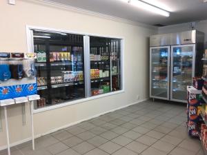 a grocery store aisle with a large window at First Camp Duse Udde - Säffle in Säffle