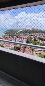 a view of a city through a wire fence at Edificio Verano in Natal