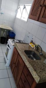 a kitchen with a sink and a stove at Edificio Verano in Natal