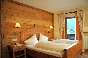 Postel nebo postele na pokoji v ubytování Hotel Neuwirt