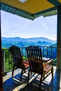 two chairs on a porch with a view of mountains at Will Guest Homestay in Ella