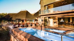 a swimming pool in the middle of a house at Zebula 8 Bedroom Lodge – IV1 in Mabula