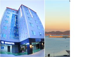 a building next to a body of water at Mj Hotel in Yeosu