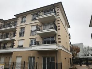 a building with balconies on the side of it at Swann Disney Appartement in Montévrain