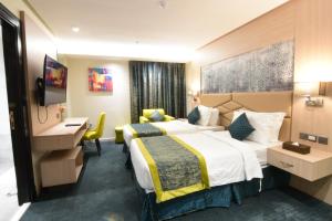 Postel nebo postele na pokoji v ubytování Touq Al Balad Hotel - فندق توق البلد