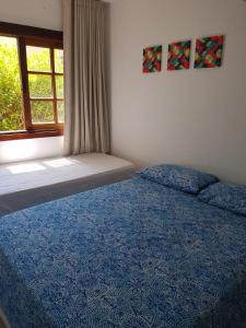 Ένα ή περισσότερα κρεβάτια σε δωμάτιο στο Porto das Baleias Praia do Forte
