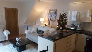 a living room with a christmas tree on a counter at The Auction House in Ryde +10 photos