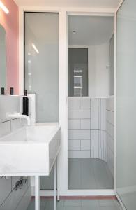 a bathroom with a white sink and a shower at Colors Urban Hotel Thessaloniki in Thessaloniki